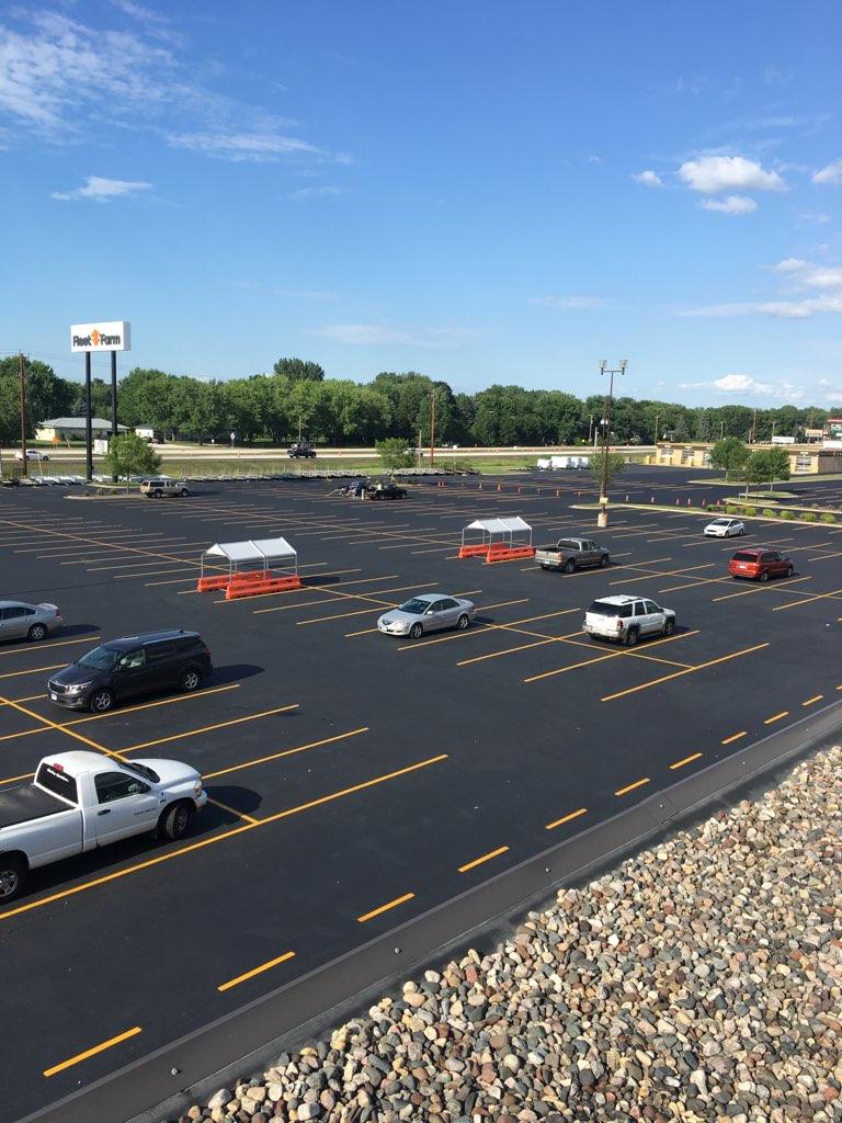 areal view of a parking lot with new sealcoating and striping