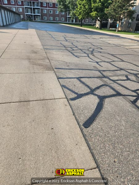 cracks being filled in an asphalt parking lot