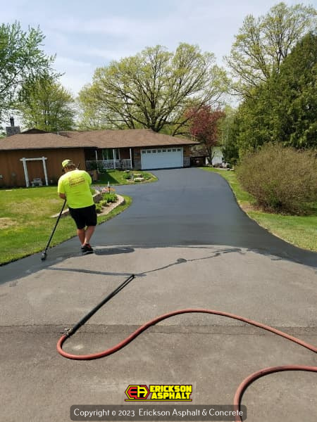sealcoating being laid on driveway