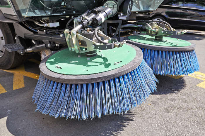 Close up of a parking lot sweeping equpiment