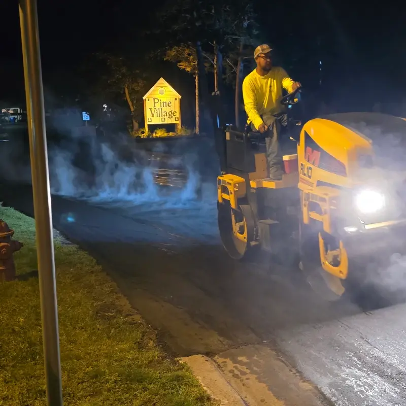 Paving at night in Pine Village