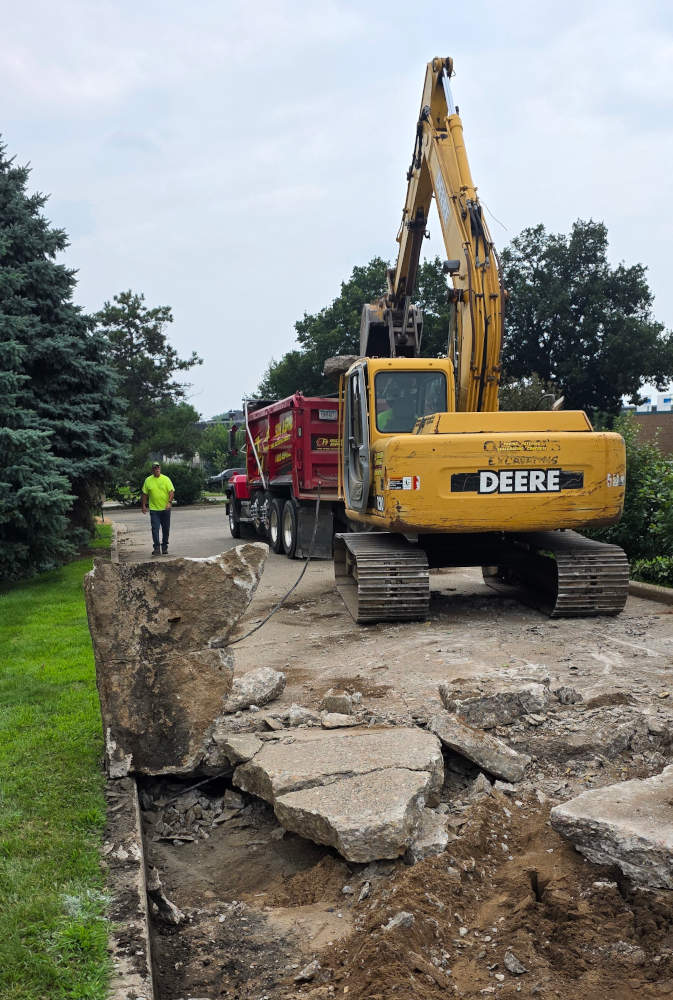 Removing concrete from CW parking lot.