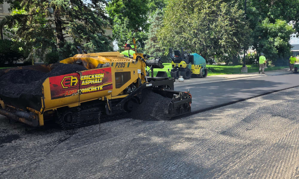 Hot mix asphalt being laid on milled parking lot