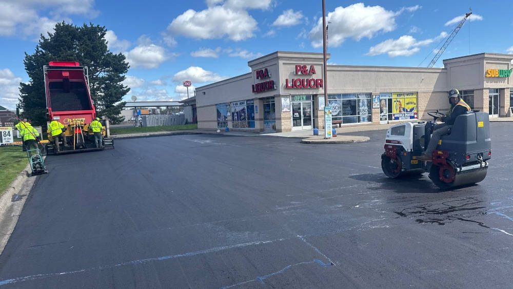asphalt being installed in a parking lot. 