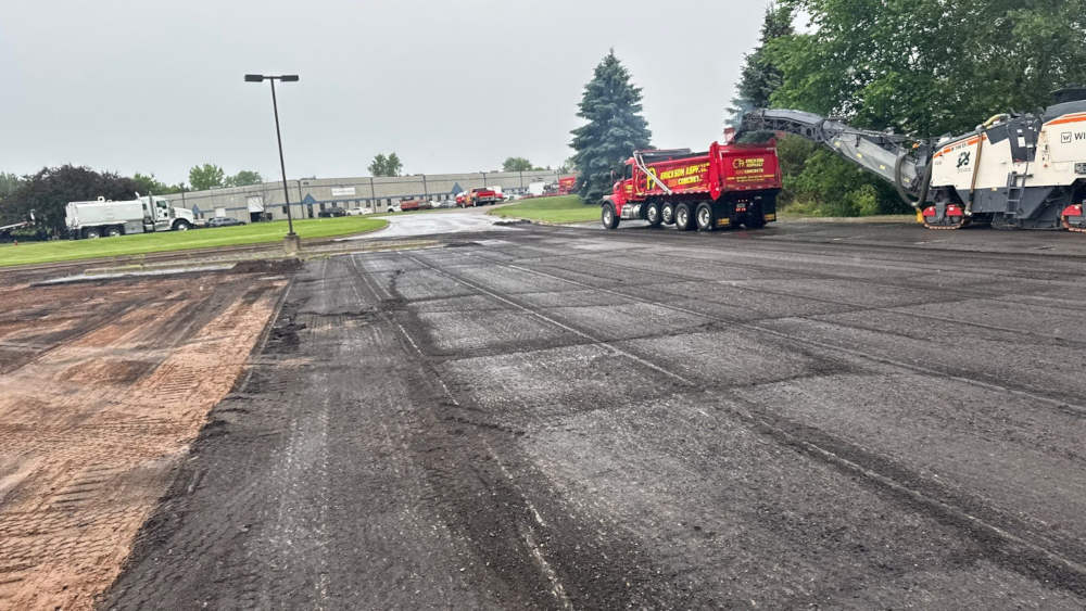 Asphalt being milled from a parking lot.