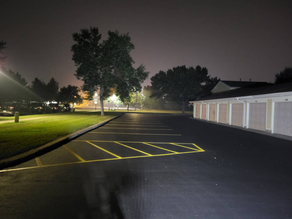 Final view of apartment building parking lot once paved and striped