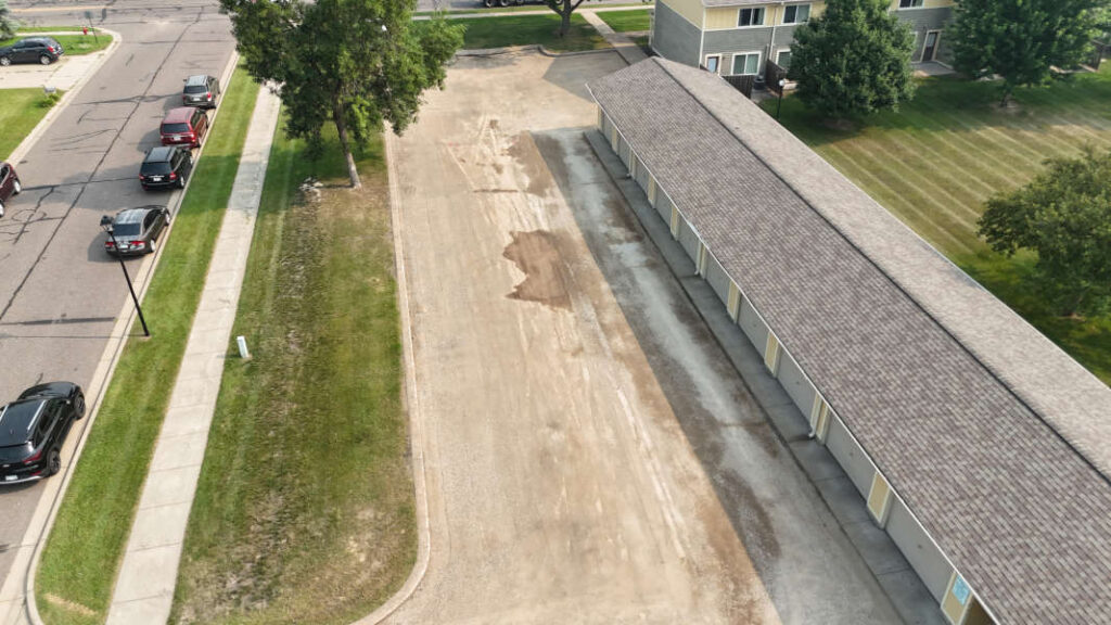 Aerial view of apartment building with the parking lot prepared for asphalt