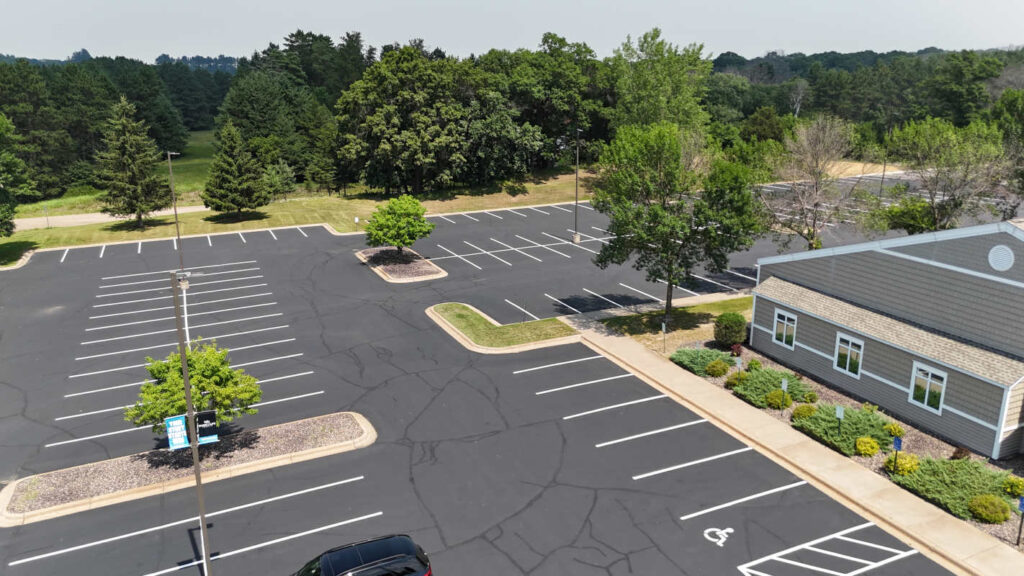 Aerial view of parking lot with dried sealcoating and new striping