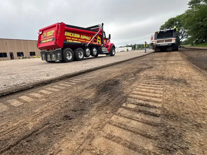 Asphalt being milled in a parking lot.