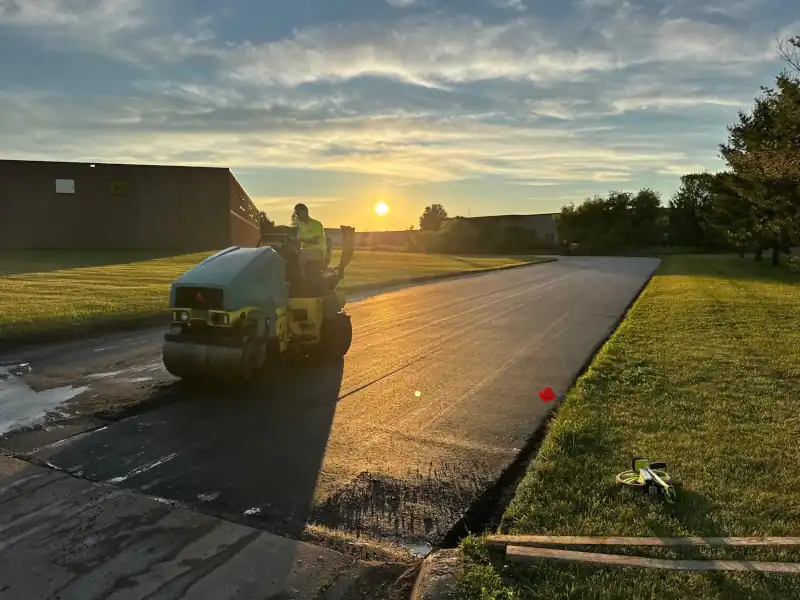 roller compacting asphalt in parking lot repair.